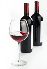 Glasses of red wine on white background.