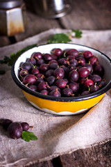 A bowl of dark gooseberries.