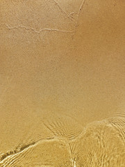 Wave of the sea on the clean sandy beach.