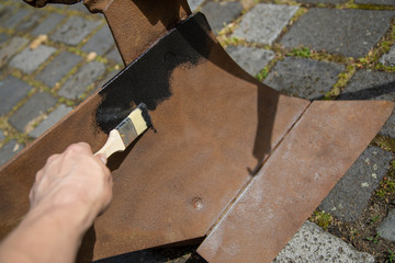 Restore old plough and paint with black paint