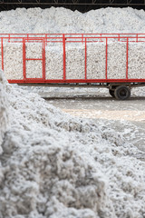 Tractor and trolley passing through the seed cotton piles in a ginning mill in Greece © Ilias Kouroudis
