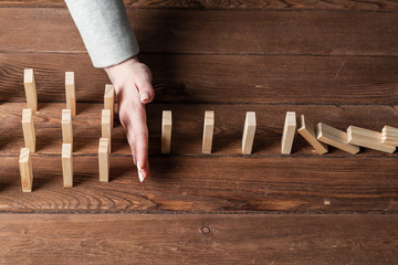 Business woman interrupting domino effect