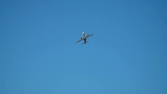 Large plane take off day. A large passenger airliner is taking of during a beautful sunny day. Slow motion close up.