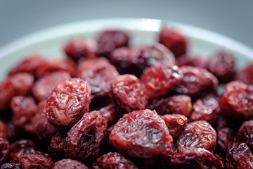 Closeup view of a White plate Full of Dried Cranberries