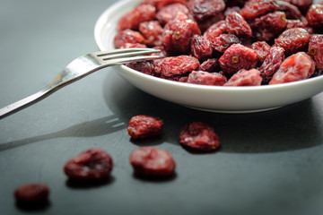 Closeup view of a White plate Full of Dried Cranberries