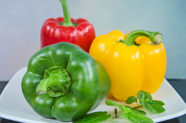 Beautiful sweet peppers and leaves close up