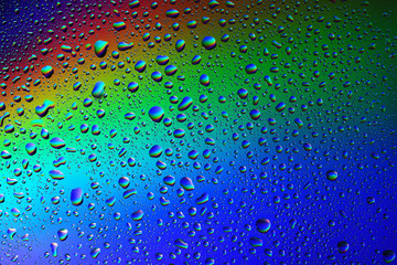 Multicolored drops on the glass