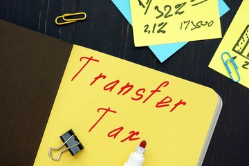 Business concept about Transfer Tax with phrase on the piece of paper.