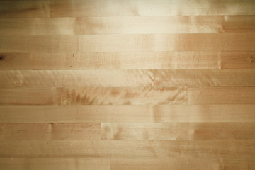 Pine wooden table background in low room light.