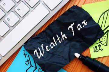 Financial concept meaning Wealth Tax with sign on the sheet.