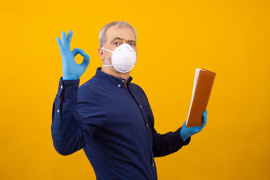Isolated Adult Or Senior Man With Book, Gloves And Mask