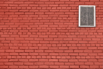 Dirty, dusty ventilation grill on a red brick wall.