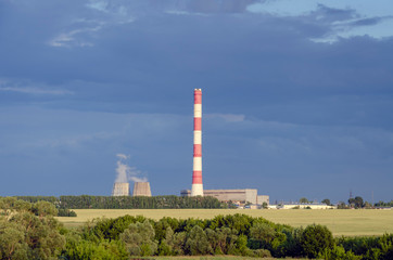 Summer evening landscape with a thermal power station. Heat and power plant at sunset.