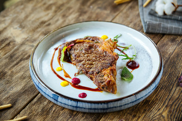 Gourmet grilled mutton steak on the wooden table