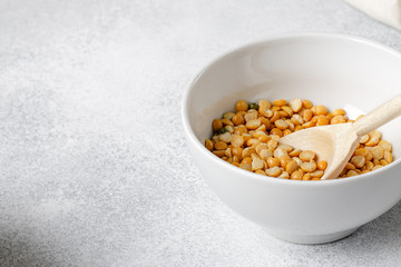 dried beans in wooden spoons on the table, close up