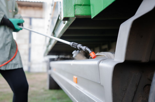 specialist wearing protective suit spray disinfectant chemicals on the cargo container or truck to prevent the spreading of the coronavirus.
logistics and freight concept
 during a pandemic - Powered by Adobe