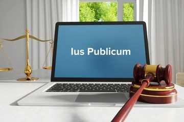 Ius Publicum – Law, Judgment, Web. Laptop in the office with term on the screen. Hammer, Libra, Lawyer.