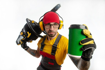 Fototapeta premium a guy in protective coveralls with a chainsaw on a white background