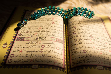 Colorful pages of the holy Quran book at sunset (Koran) | Islam | Ramadan Kareem and Eid Mubarak - obrazy, fototapety, plakaty