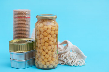 canned food, cookies, chickpea on blue background