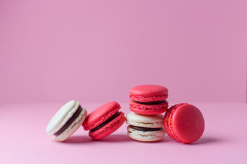 Beautiful colourful desserts. french macaroons on a pink background