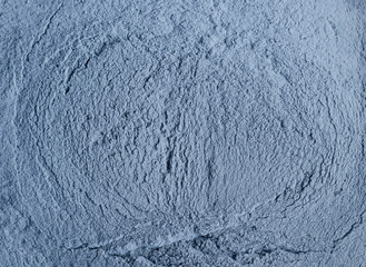 Light blue bentonite facial clay powder (alginate mask, face cream, body wrap) texture close up,...