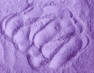 Purple facial cream powder (alginate face mask, body wrap, hair conditioner) texture close up, selective focus. Lavender abstract background.