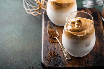 Dalgona coffee in glass cup. Korean trendy drink from instant coffee, milk and ice. Summer beverage...
