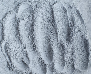 Gray bentonite facial clay powder (alginate mask, face cream, body wrap) texture close up,...