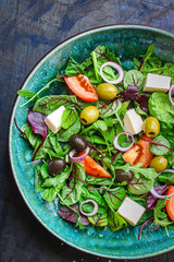 healthy salad
olives, lettuce, tomato and cheese
feta (greek salad, tasty vegetables snack) menu concept background. top view. copy space for text
