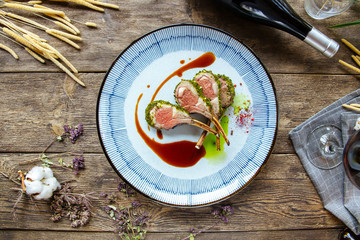 Top view herb-crusted lamb chopswith spinach