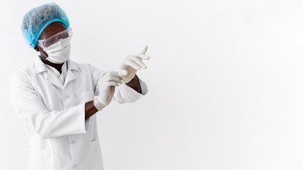 Male black doctor wearing mask and gloves