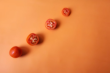 Tomatoes pattern isolated on orange background.