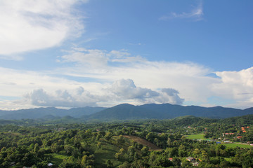 View of green vegetation and mountains from above the Big Buddha of Chiang Rai