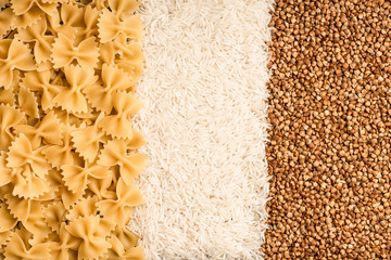 Heap of glutinous Pasta, rice and buckwheat on grey background