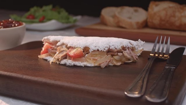 Brazilian tapioca with tuna, tomato and onion