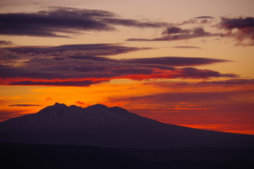 夜明けの太陽に色づいた雲。美しい稜線のシルエット。美幌峠からの朝の眺め。北海道、日本。