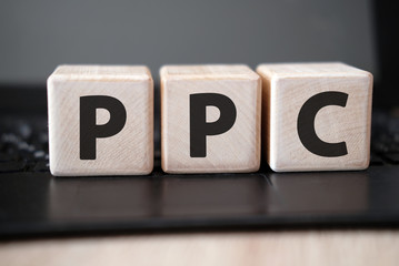 PPC - concept on wooden cubes on a black keyboard