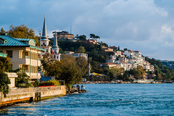 Naklejka premium Traditional and modern mansions on the Bosporus Strait waterside, Turkey Istanbul Boat trip along the Golden horn Bay in Istanbul.