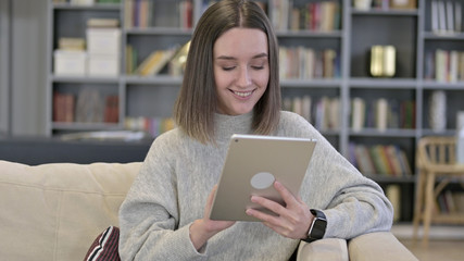 Portrait of Attractive Young Woman using Tablet