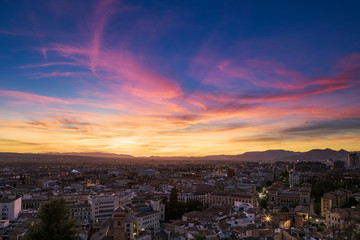Aerial view of Granada, with a spectacular and colorful sky at sunset.