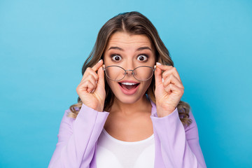 Close-up portrait of her she nice attractive lovely amazed glad cheerful cheery wavy-haired girl wearing putting of specs isolated over bright vivid shine vibrant blue color background
