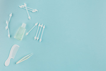 Children's personal care kit. Baby's accessories on blue background, top view.