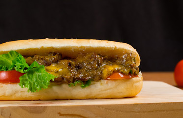 Delicious Beef Burger Steak Supreme with Lettuce And Tometo Served on Wooden Table