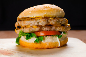 Close Up On Crispy Double Chicken Burger With Lettuce and Tomato