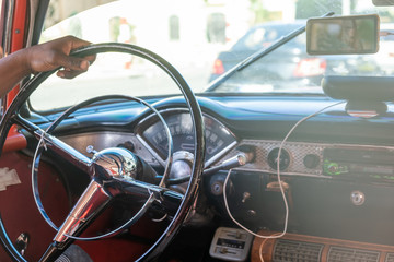 Close Up Shot Of Hand Of A Man Holding The Metal Steering Wheel Of Vintage Car On The Traffic Road.