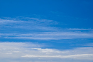 Blue sky with few blurred clouds on a sunny spring day