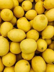 lots of ripe yellow lemons for cooking as a background