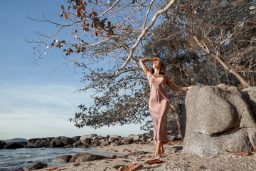 sexy young woman posing on the coast             