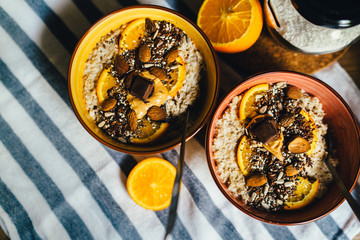 Healthy nutritious coconut whole grain oatmeal porridge breakfast with seed variety and orange peel.Fragrant and delicious morning meal.Chia and flax seed.Weight loss keto seed diet.Seed cycling.